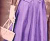 Vintage photo of woman with white gloves, white purse and long purple skirt