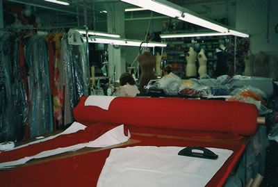 Design room with roll of velvet, paper patterns and pattern weights