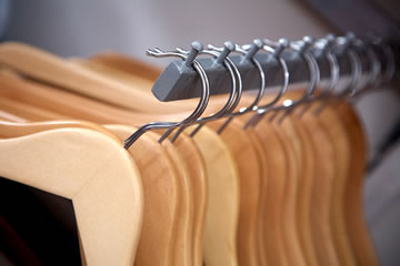 Photo of wooden clothes hangers on a rod